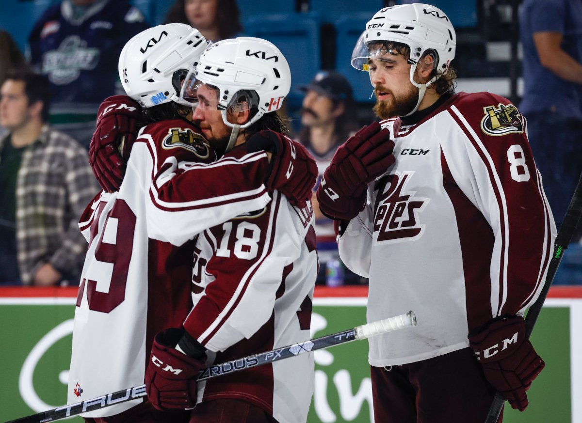 Peterborough Petes forward Connor Lockhart, centre, is consoled by a teammate after the they were defeated in semifinal CHL Memorial Cup hockey action against the Seattle Thunderbirds in Kamloops, B.C., Friday, June 2, 2023.