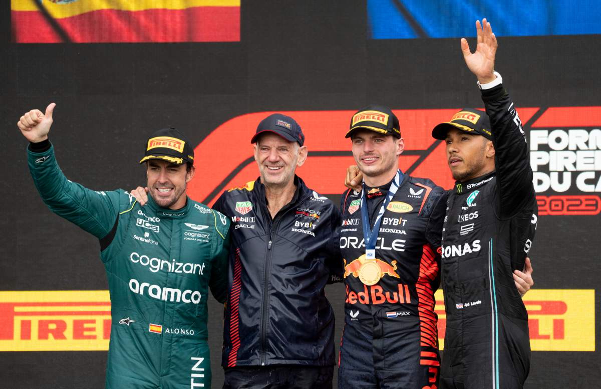 Winner Red Bull Racing Max Verstappen of the Netherlands, and his technical director, Adrain Newey, stand next to second place finisher Aston Martin driver Fernando Alonso, left, of Spain, and third place Mercedes driver Lewis Hamilton of Great Britain, during victory ceremonies following Formula One auto racing action at the Canadian Grand Prix in Montreal, Sunday, June 18, 2023.