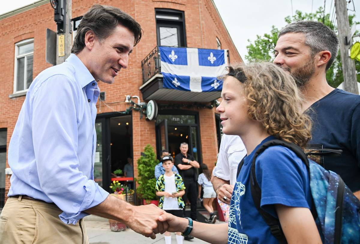 Prime Minister Justin Trudeau greets a young boy during an event on Saint-Jean-Baptiste in Montreal, Saturday, June 24, 2023.