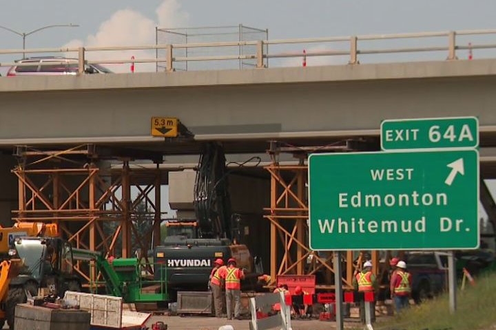 Work begins to move excavator stuck under overpass by east part of Edmonton’s Anthony Henday Drive