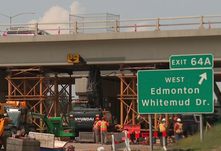 Work has begun to remove the excavator that's stuck under the Whitemud overpass on the southeast part of Anthony Henday Drive in Edmonton for nearly two weeks.