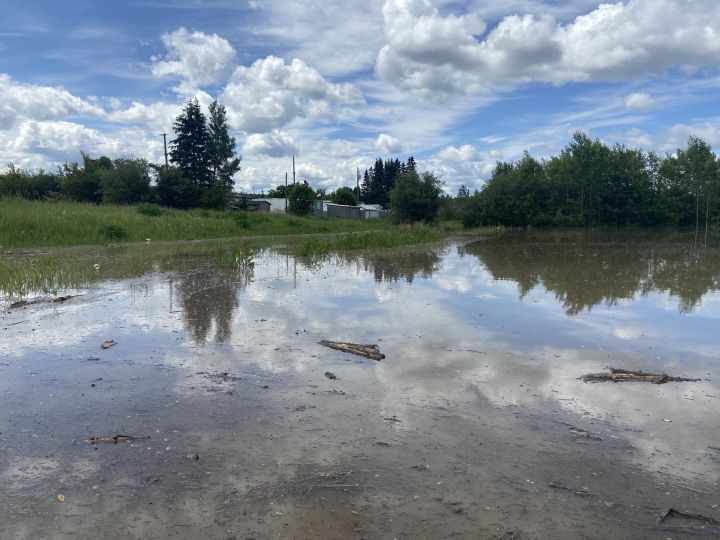 Large pools of water left by heavy rain seen in Whitecourt, Alta., on June 20, 2023.