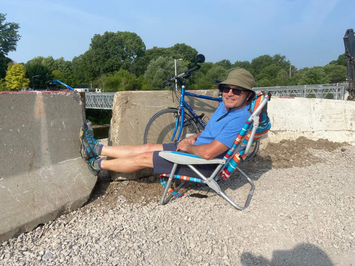 Old South resident Jeff Kuchta watching one steel arch of the new Victoria Bridge being lifted into place in London, Ont., on Tuesday, June 20, 2023.