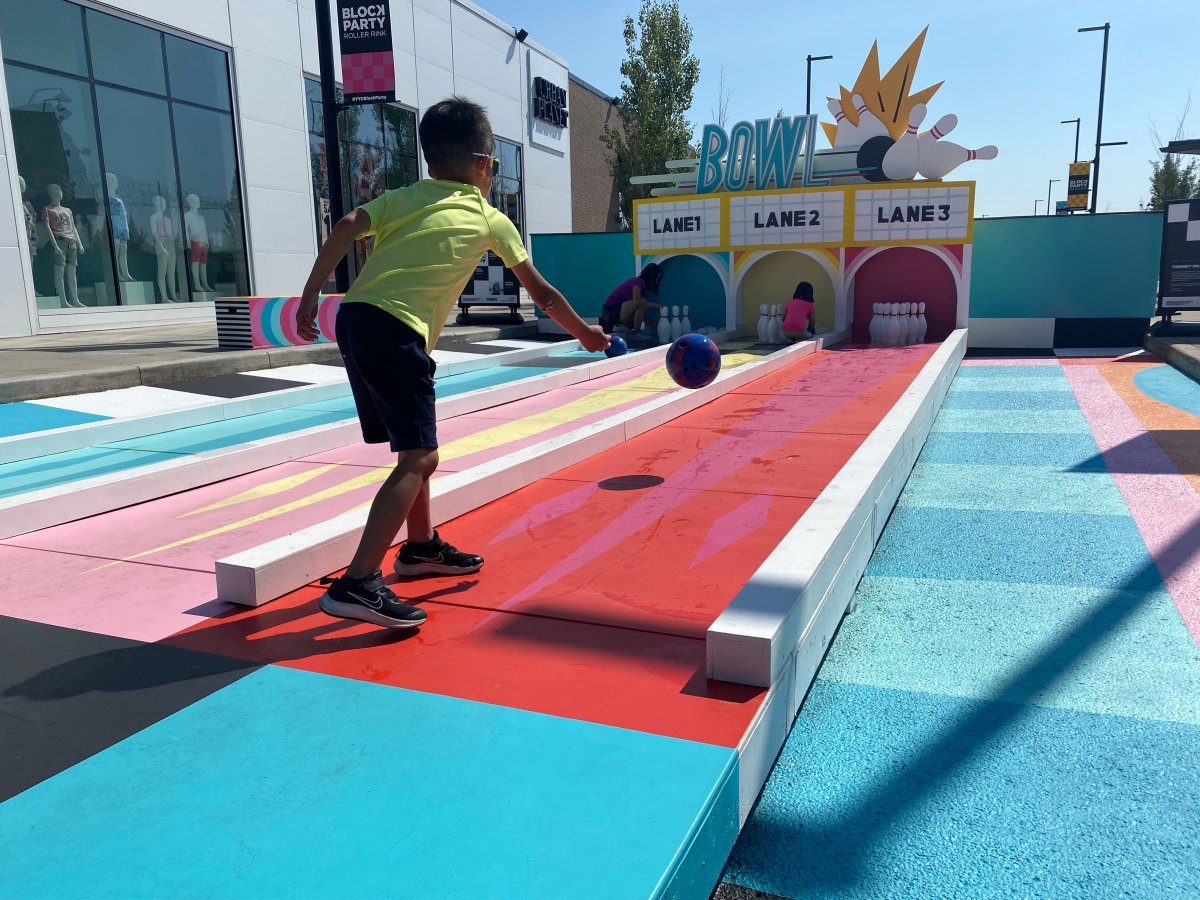 Luke Hui, 8, tries out the ‘Nostalgia Strikes' outdoor bowling alley at Deerfoot City Mall in northeast Calgary on a sunny day in June 2023.