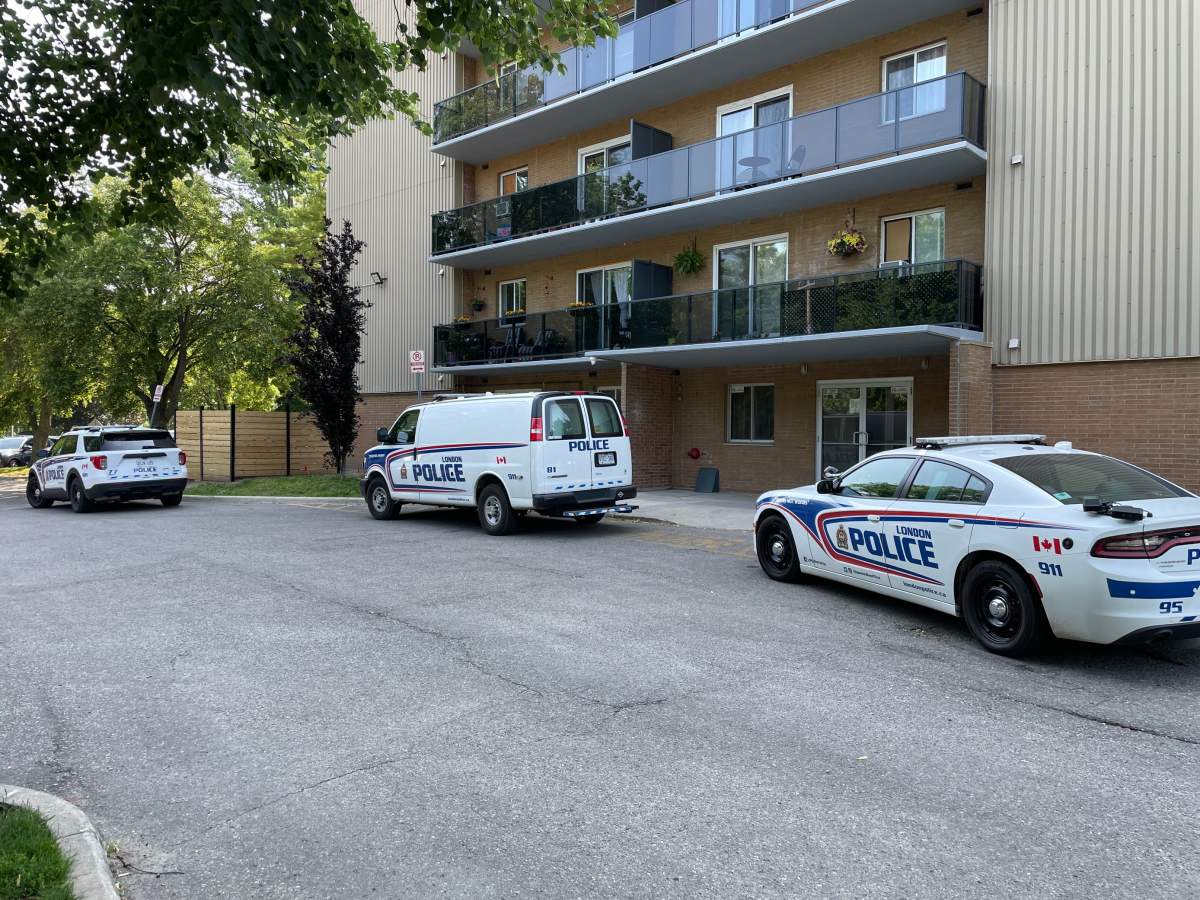 Three police vehicles outside of an apartment building on Emery Street.