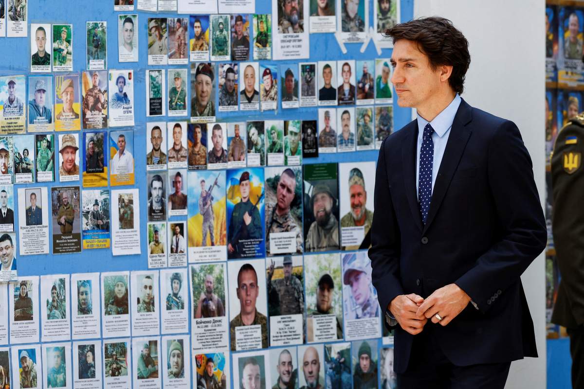 Trudeau looks at a wall of those missing and killed during the war in Ukraine