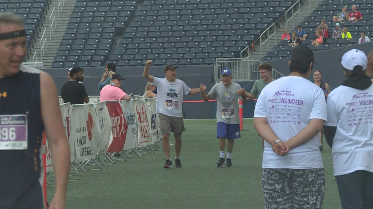 The Bochniski’s crossing the finish line holding hands