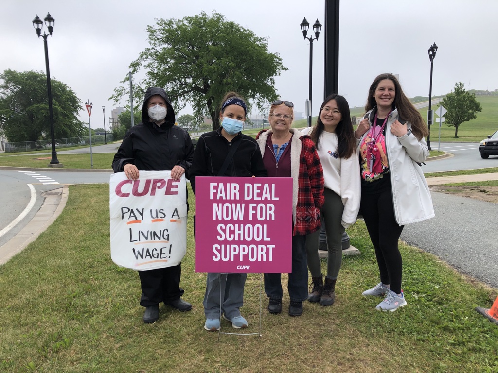 School support workers wave at passing cars outside Citadel High School on Thursday, June 15th. Educational Program Assistant Linda Dunn-Colley (centre) has worked as an EPA at Citadel High for 15 years.