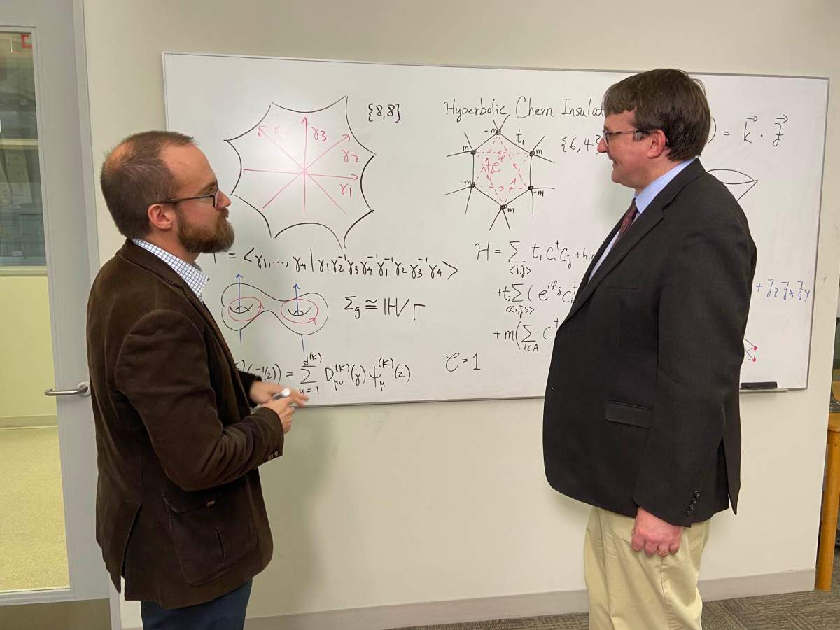 A photo of two scientists discussing quantum physics.