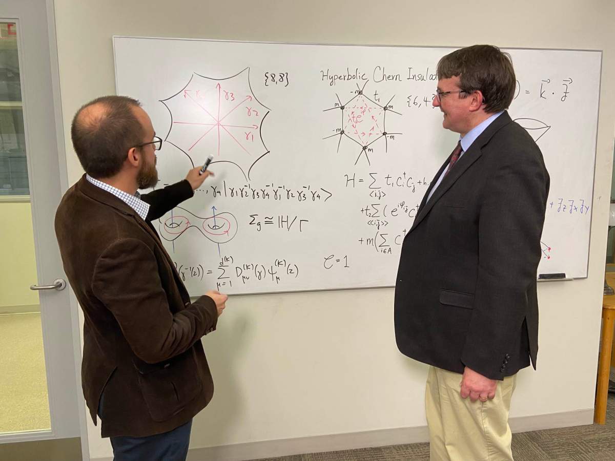 A photo of two scientists discussing quantum physics.