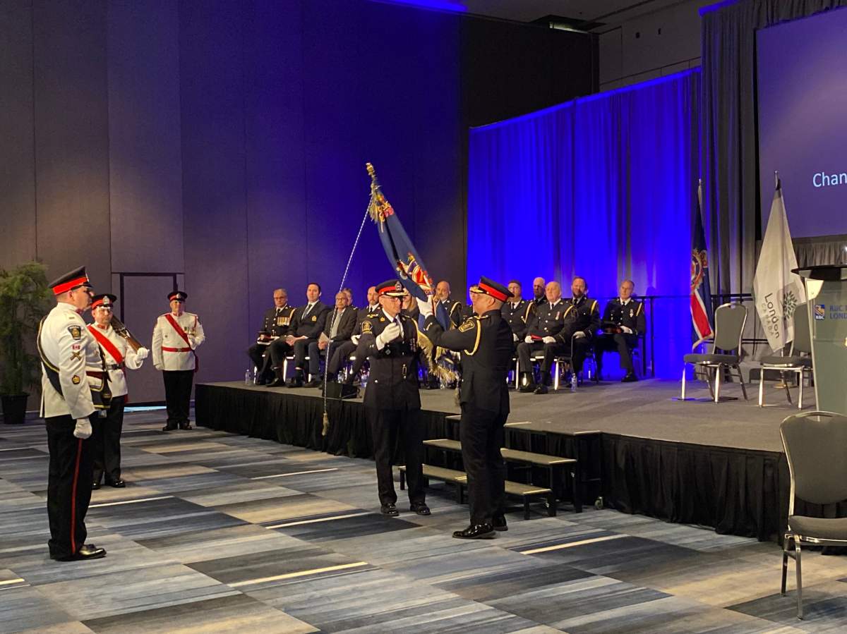 The exchange of London Police Service Colour between retired chief Steve Williams and new Chief Thai Truong on June 26, 2023.