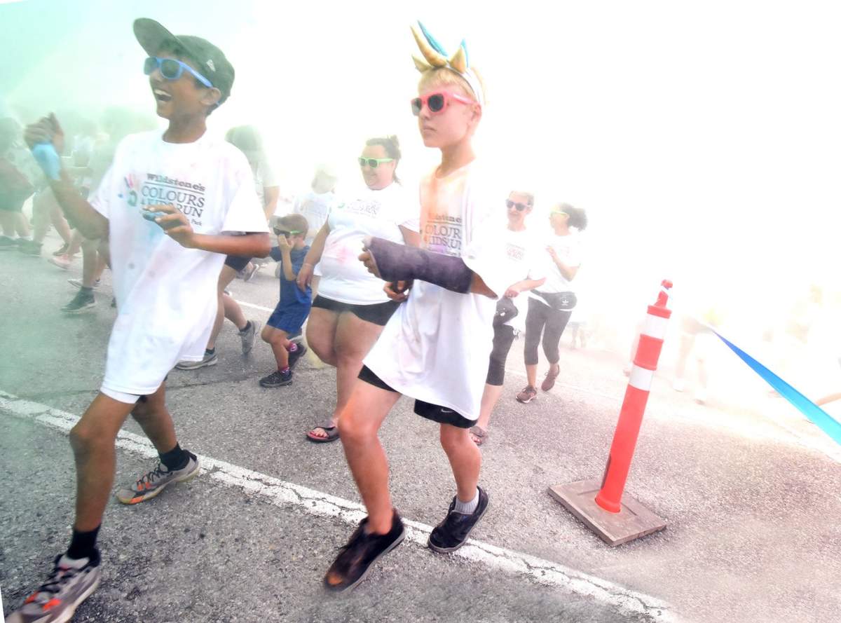 Some of the 700-plus participants leave the start line in a fog of colour at the Wildstone Colours4Kids Run in support of the OSNS Child and Youth Development Centre.