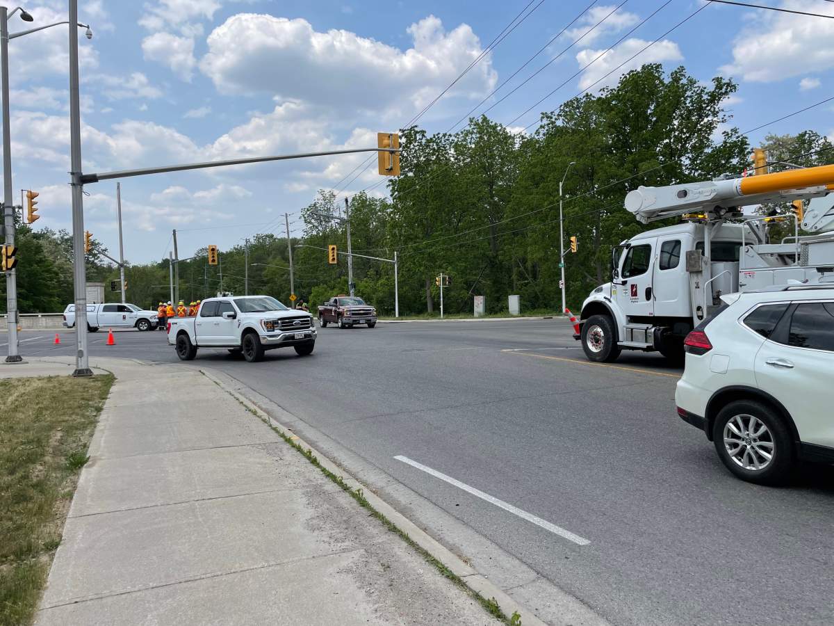 Traffic being re-routed at the intersection of Windemere Road and Western Road following a collision that caused a series of power outages in north London, Ont., on Friday, June 2, 2023.