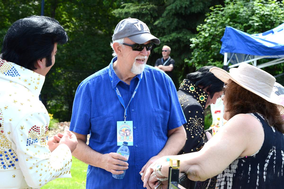Former Elvis Presley personal bodyguard Sam Thompson talks with people about his time with the King to those attending the outdoor competition at the Penticton Pacific Northwest Elvis Festival on Saturday.