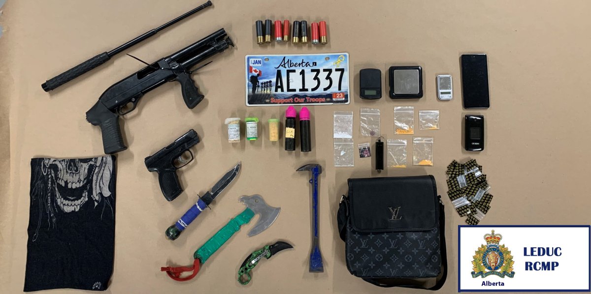 An image of the firearms, edged weapons, drugs and license plate RCMP found in the vehicle they performed a traffic stop on.