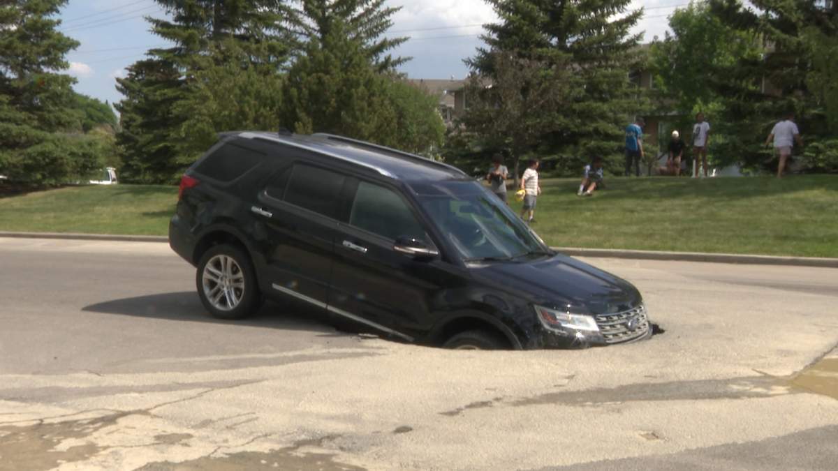 An SUV stuck in a sinkhole on Silver Ridge Close N.W. on June 8.
