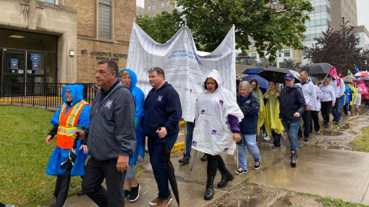 Nurses, PSWs and lab techs rallied in front of St. Joseph's Healthcare's Charlton Avenue campus June 12, 2023 and delivered a petition calling on hospital leadership to oppose Bill 60.