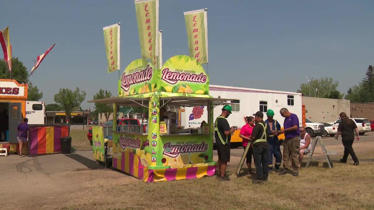 Wild Rose Shows owner Mike Kryzanowski and his daughter Mikayla speaking with staff at Devon Days on Friday, June 9, 2023.
