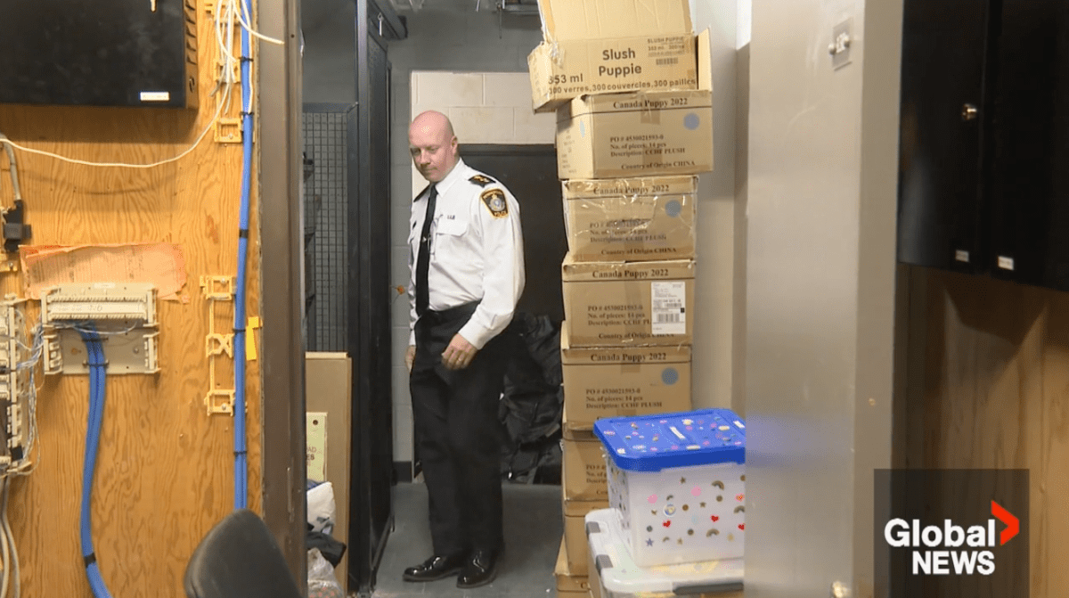 Peterborough Police Service Chief Stuart Betts manoeuvres around boxes in a hallway at the station on Water Street on June 15, 2023.