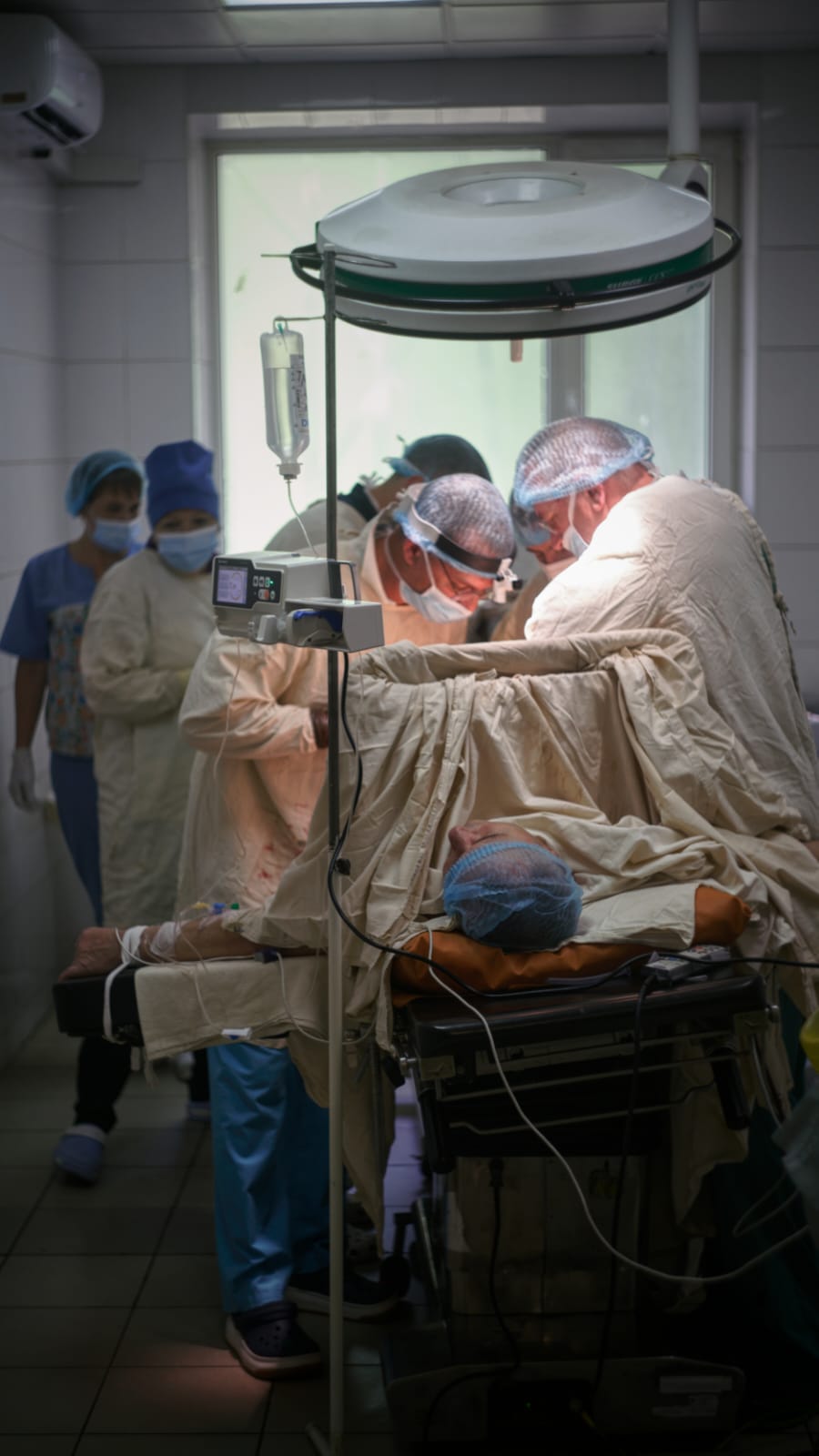 Ukrainian trauma surgeons operate on a solider.