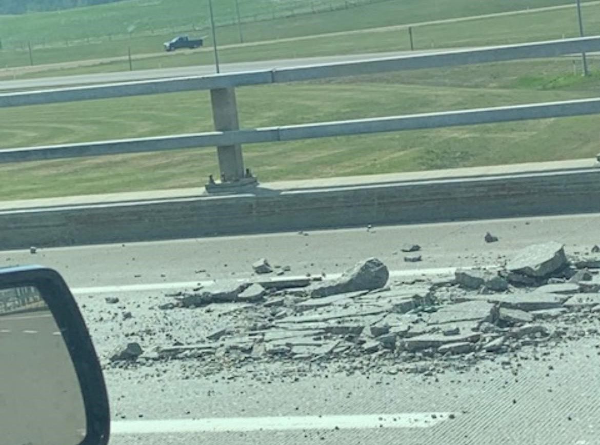 Pavement damaged on the Whitemud Drive bridge deck after a semi hauling an excavator hit the underside of the overpass while exiting Anthony Henday Drive in southeast Edmonton on Friday, June 16, 2023.
