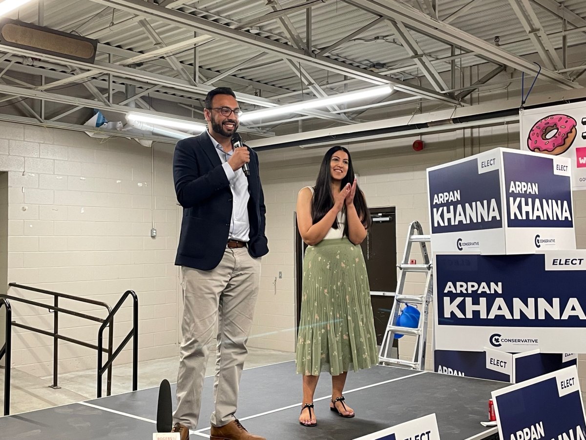 Arpan Khanna addresses a crowd in Woodstock with his wife Sim after declaring victory in the federal Oxford byelection on June 19, 2023.