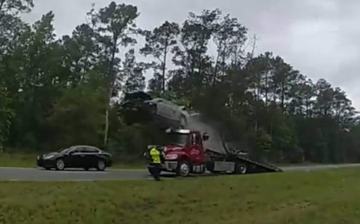 The car hit the ramp of the tow truck and was launched high into the air.