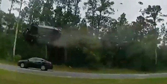 The car is seen in mid-flip.