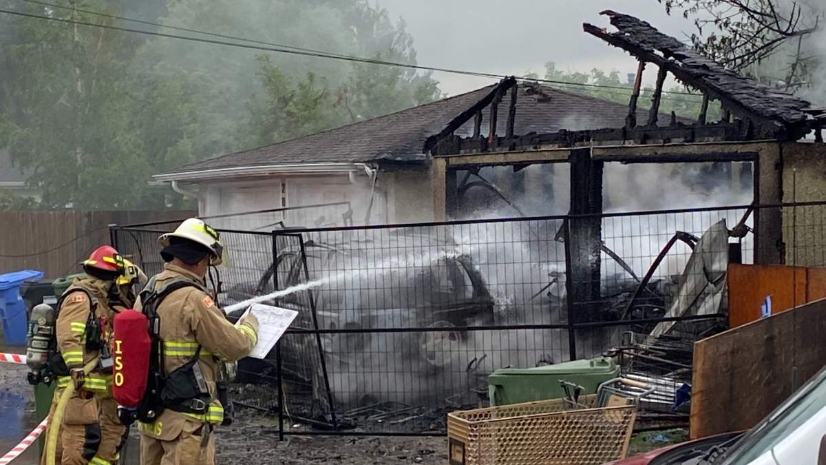 Calgary Fire Department firefighters douse a charred garage in Glenbrook during a June 1 response.