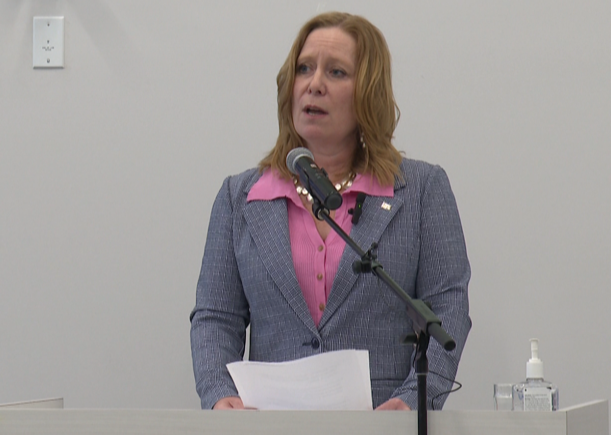 NB housing minister Jill Green speaks at a podium