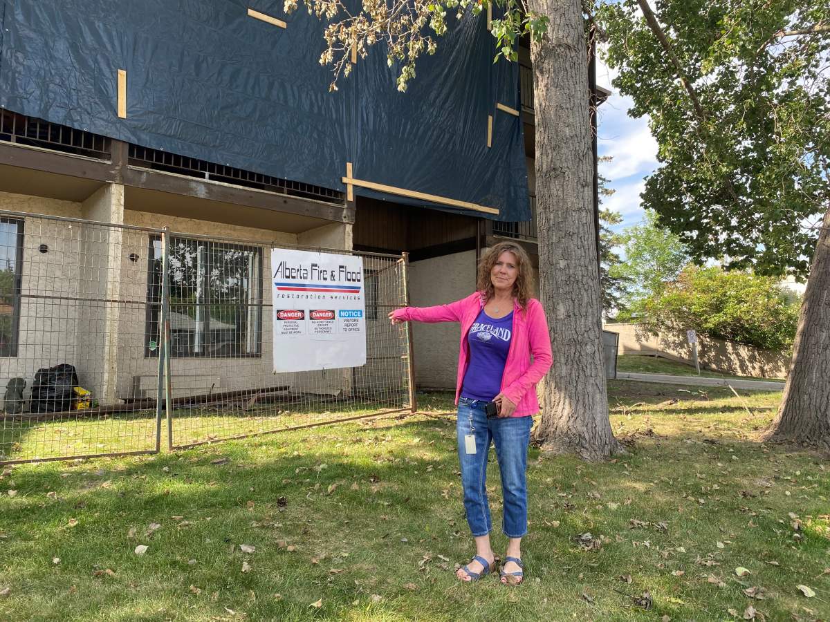 Calgary renter in front of partially burned building