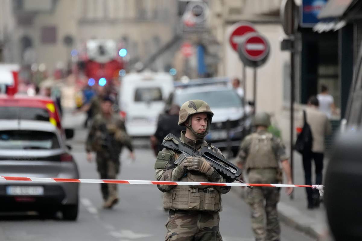 A soldier secures the are as firemen fight a blaze Wednesday, June 21, 2023 in Paris. (AP Photo/Christophe Ena)