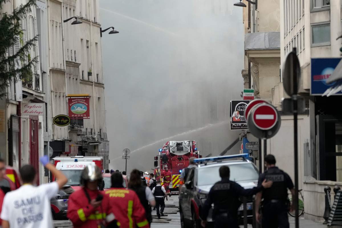 Firemen use a water canon as they fight a blaze Wednesday, June 21, 2023 in Paris. (AP Photo/Christophe Ena)