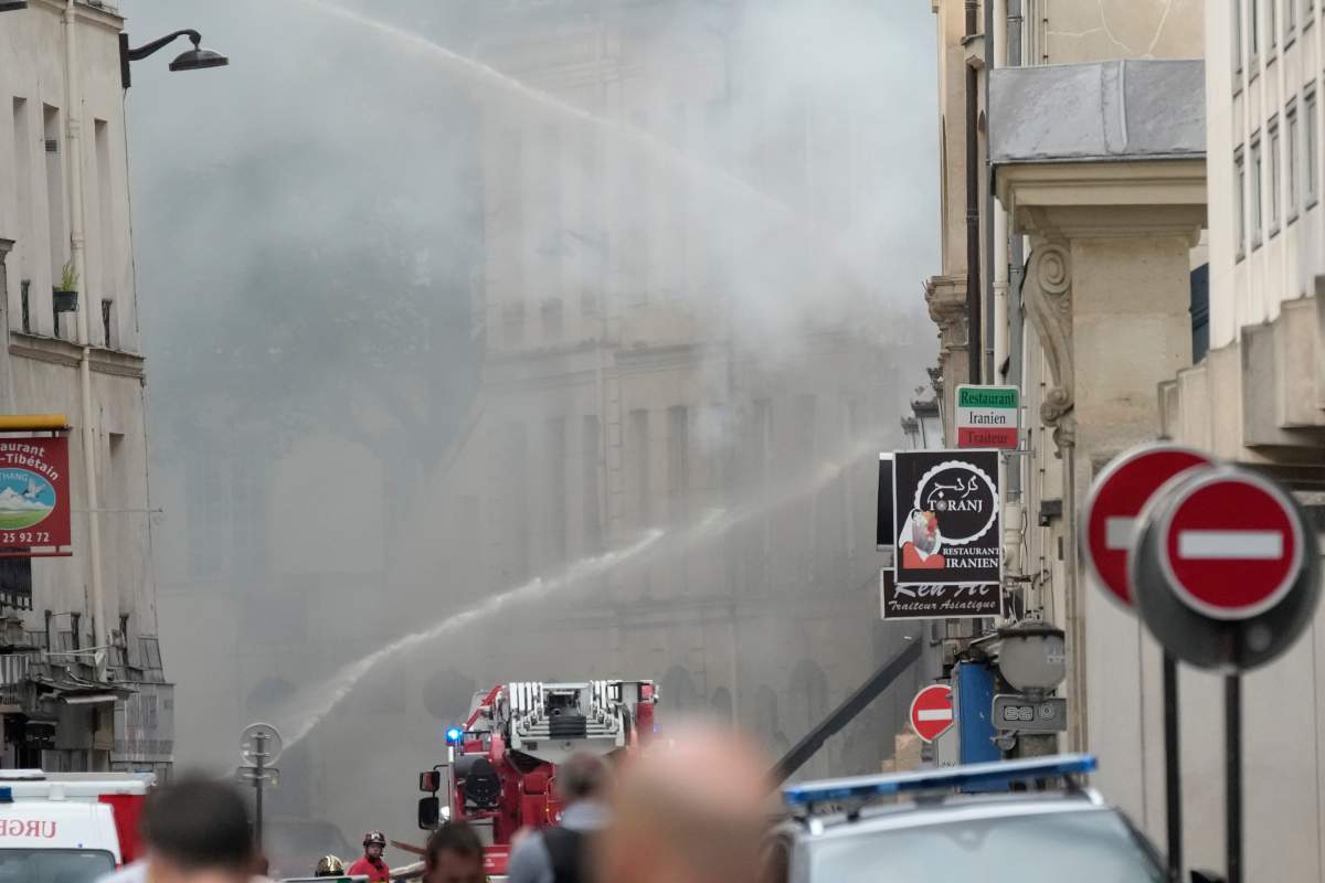 Firemen use a water canon as they fight a blaze Wednesday, June 21, 2023 in Paris. (AP Photo/Christophe Ena)