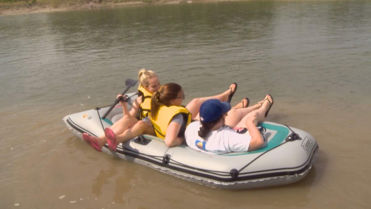 People in a water raft on the Oldman River. 