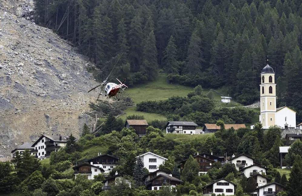 A helicopter flies over the rockfall "Brienzer Rutsch" above the village Brienz-Brinzauls in Switzerland, Friday, June 16, 2023.