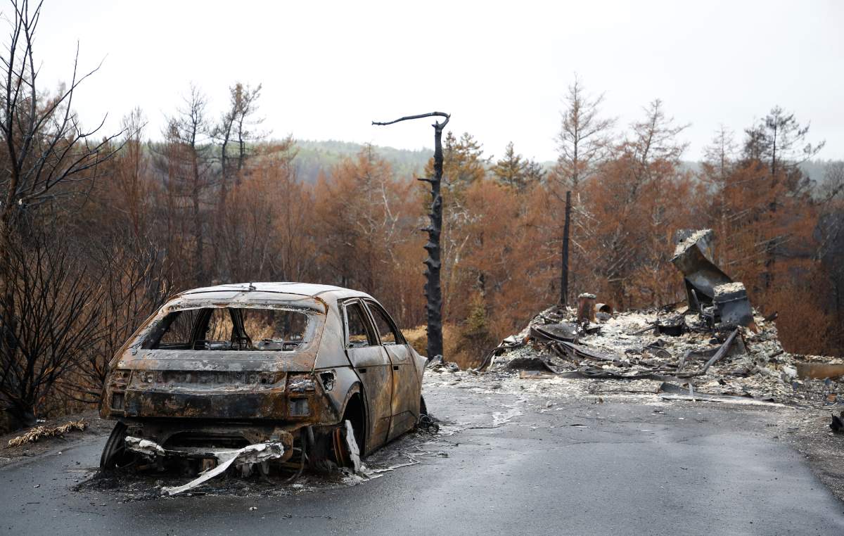A destroyed car and home are seen on Carmel Crescent following last week’s wildfire in Hammonds Plains, N.S. Tuesday June 6, 2023.