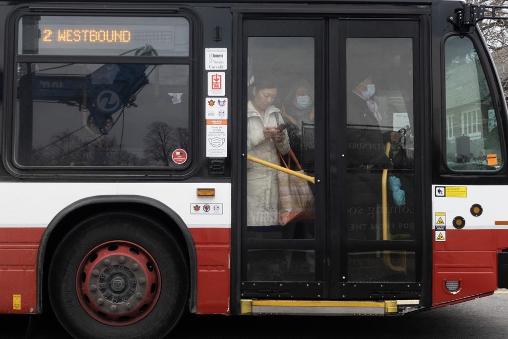 People ride on a shuttle bus outside a west-end Toronto subway stop after subway service was closed during the morning commute Wednesday, April 5, 2023. Toronto had the least reliable transit system in 2022 compared to other municipalities in the region, according to newly released transit report cards from the Toronto Region Board of Trade. THE CANADIAN PRESS/Graeme Roy.