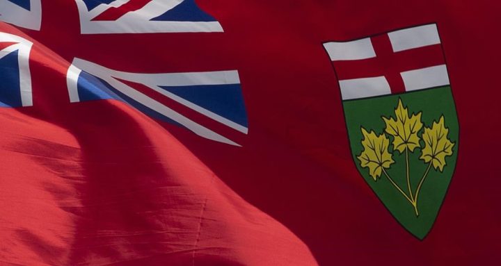 Ontario's provincial flag flies on a pole in Ottawa, Tuesday, June 30, 2020. A date has been set for a coroner's inquest into the deaths of three construction workers who all died after being hit by motor vehicles at separate construction sites. 