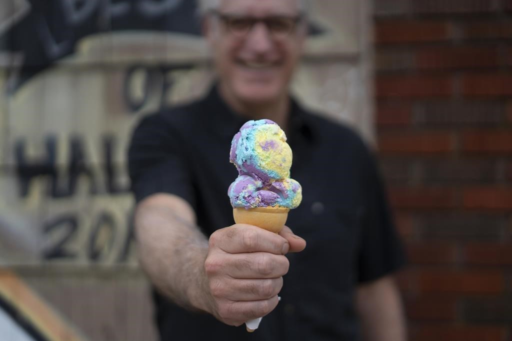 Peter O'Brien holds a cone of Moon Mist ice cream, the most popular flavour of ice cream in Atlantic Canada, in Halifax on Tuesday, July 4, 2023. O'Brien's grandfather ran a creamery where O'Brien says his grandfather invented the flavour known today as Moon Mist before the flavour combination was shopped around to different dairies. THE CANADIAN PRESS/Darren Calabrese