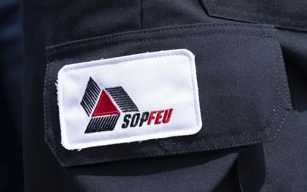 A SOPFEU patch is seen on the leg of an employee near Lebel-sur-Quevillon, Que., Wednesday, July 5, 2023. Quebec's forest fire prevention agency is reporting no out-of-control wildfires for the first time since the end of May. 