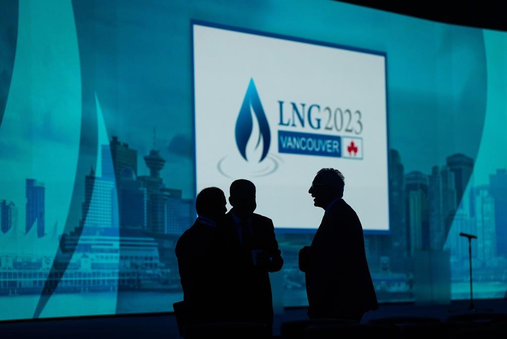 Delegates are silhouetted before the start of the LNG2023 conference, in Vancouver, B.C., Mon. July 10, 2023.