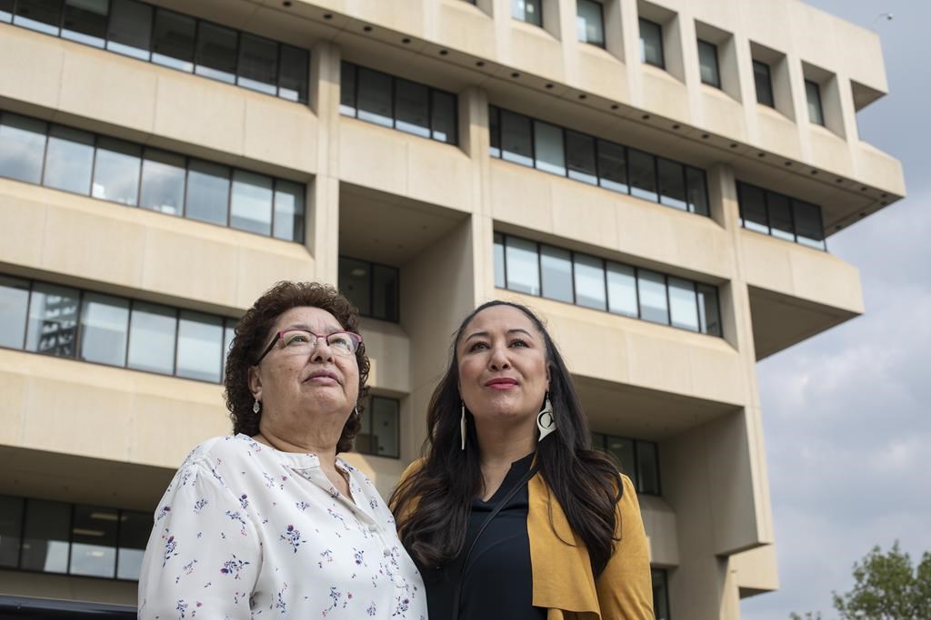 May Sarah Cardinal and her daughter, Anita Cardinal, stand for a portrait outside the Law Courts building in Edmonton, Alberta, Canada on Thursday, May 25, 2023. There are at least five class-action lawsuits against health, provincial and federal authorities involving forced sterilizations in Alberta, Saskatchewan, Quebec, British Columbia, Manitoba, Ontario and elsewhere. May Sarah is the representative plaintiff in the Alberta class action. (AP Photo/Amber Bracken).