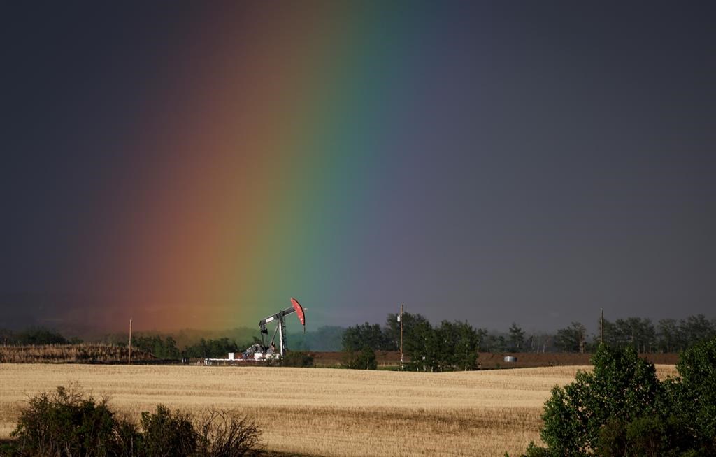 Analysts say they're expecting strong second quarter earnings from Canadian heavy oil producers. A pumpjack draws out oil and gas from a well head as a rainbow shines down on it near Calgary, Alta., Sunday, May 28, 2023.