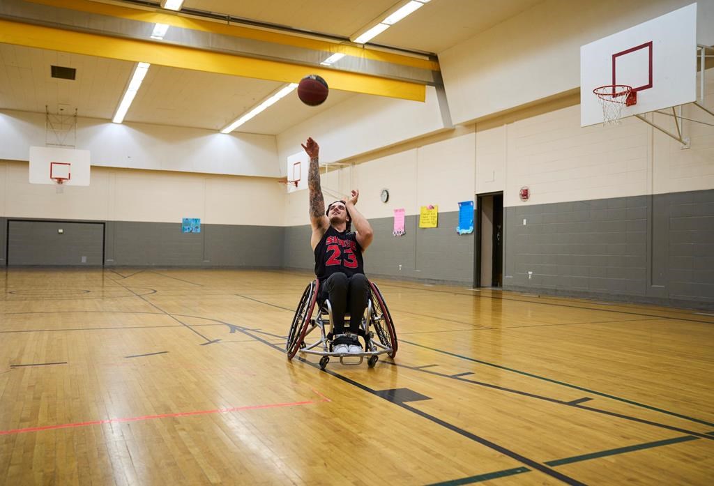 Ryan Straschnitzki, one of the Humboldt Bronco hockey players injured in the Humboldt bus crash, shoots hoops during a media event in Calgary, Alta., Thursday, July 27, 2023.