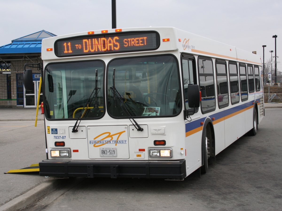 A photo of a City of Burlington bus parked at a transit terminal.