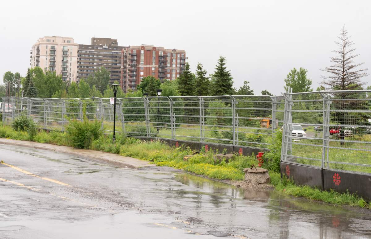A fence surrounds the vacant lot of the former Hippodrome racetrack, which the city of Montreal plans to develop into subsidized housing, in Montreal, Thursday, June 29, 2023.