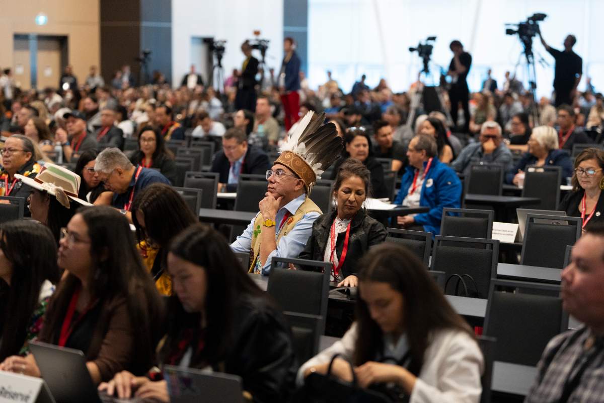A group of people sit in chairs looking forward