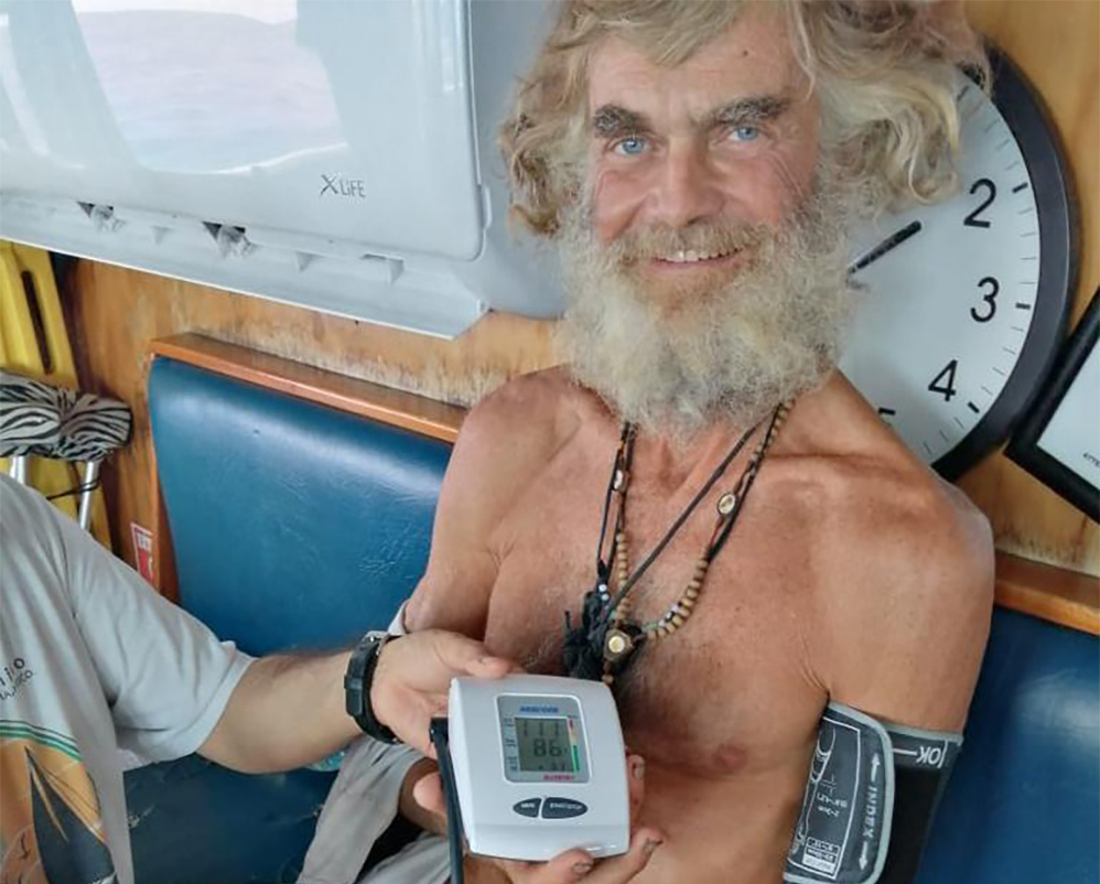 In this photo provided by Grupomar/Atun Tuny, Australian Tim Shaddock has is blood pressure taken after being rescued by a Mexican tuna boat in international waters, after being adrift with his dog for three months. Haddock and his dog Bella were aboard his incapacitated catamaran Aloha Toa some 1,200 miles from land when they were rescued.