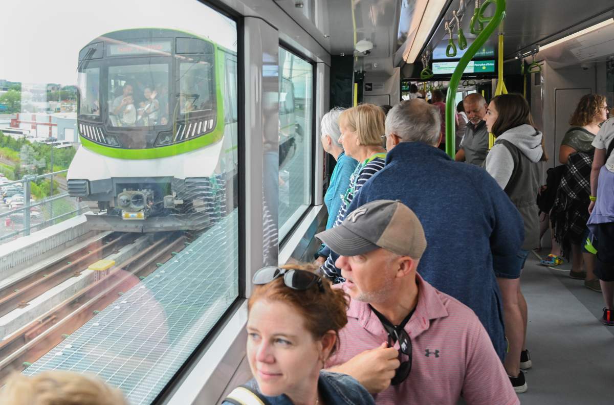 People take a ride on the Reseau express metropolitain (REM) light rail system in Montreal, Saturday, July 29, 2023. The REM opens Monday to fare paying passengers.